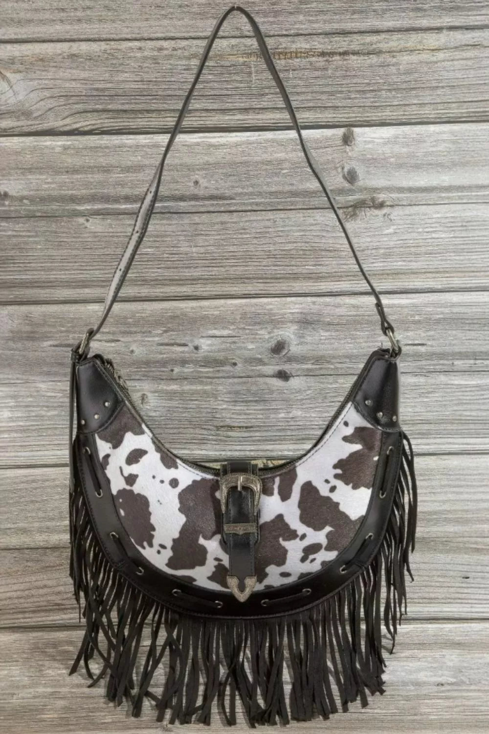 Fame Cow Print Faux Leather Fringe Hobo Bag